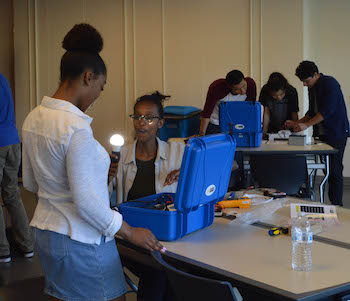 Environmental Studies students illuminating a light bulb in the class room. Credit: Dr. Ernita Joaquin