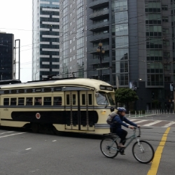 Bicycle rider and trolley in downtown San Francisco